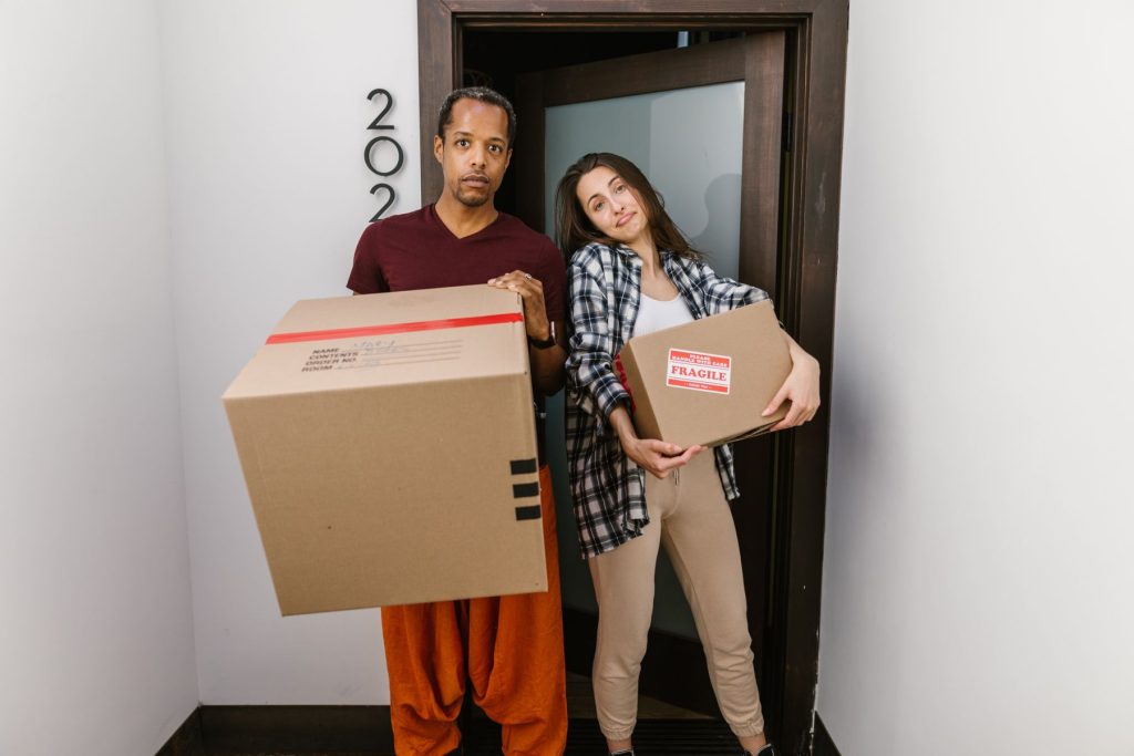 Crew member handing off a box to a client