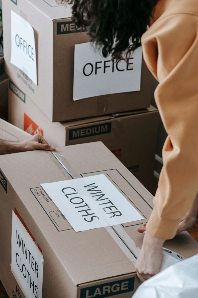 Mover taping and sealing a labeled box