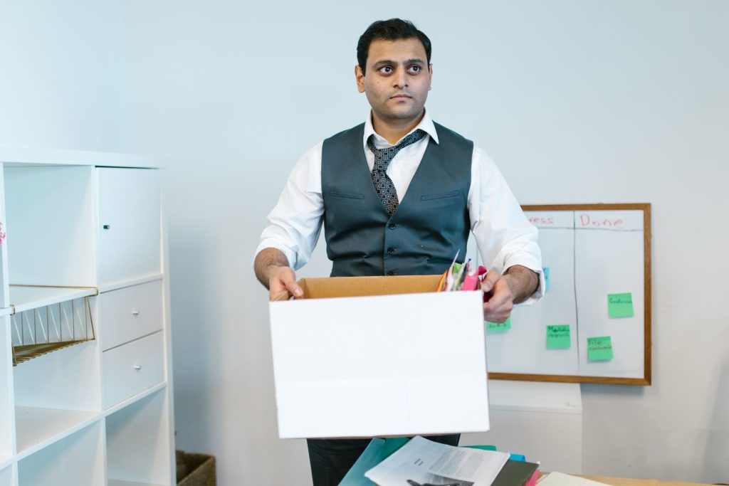 Office worker packing belongings into a box