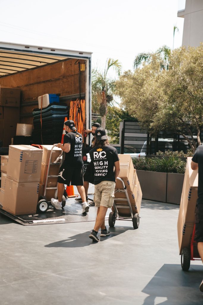 Movers loading boxes into a truck on a sunny day